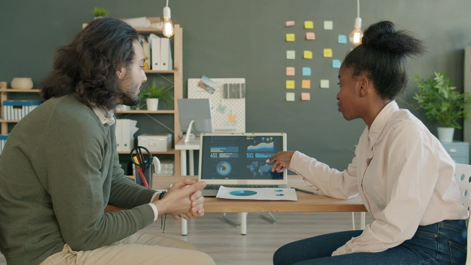 Two colleagues reviewing data together on a laptop
