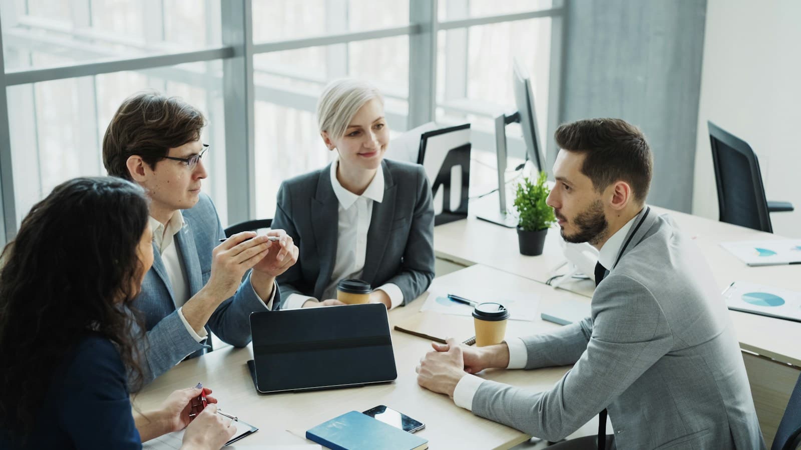 Business leaders in discussion around a meeting table
