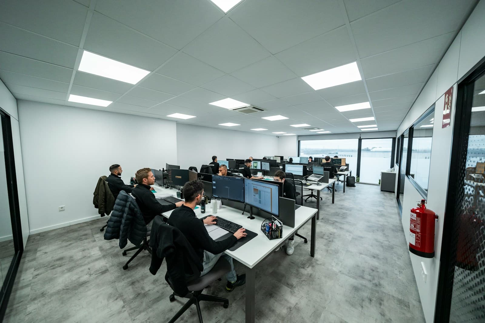 Professionals working at computers in an open-plan office