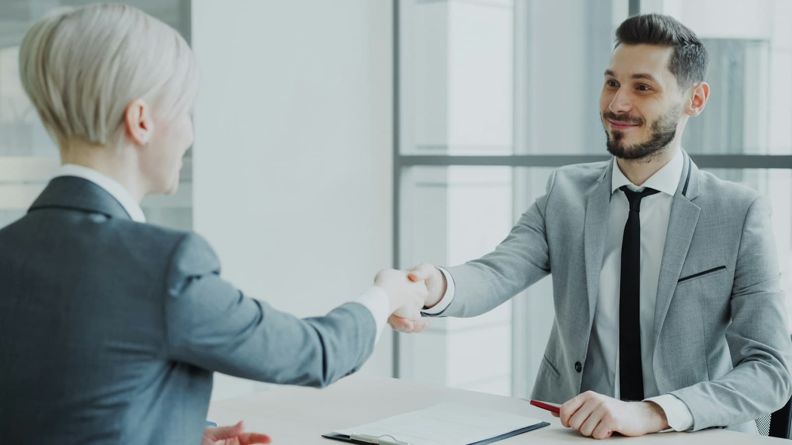 A candidate and interviewer shaking hands