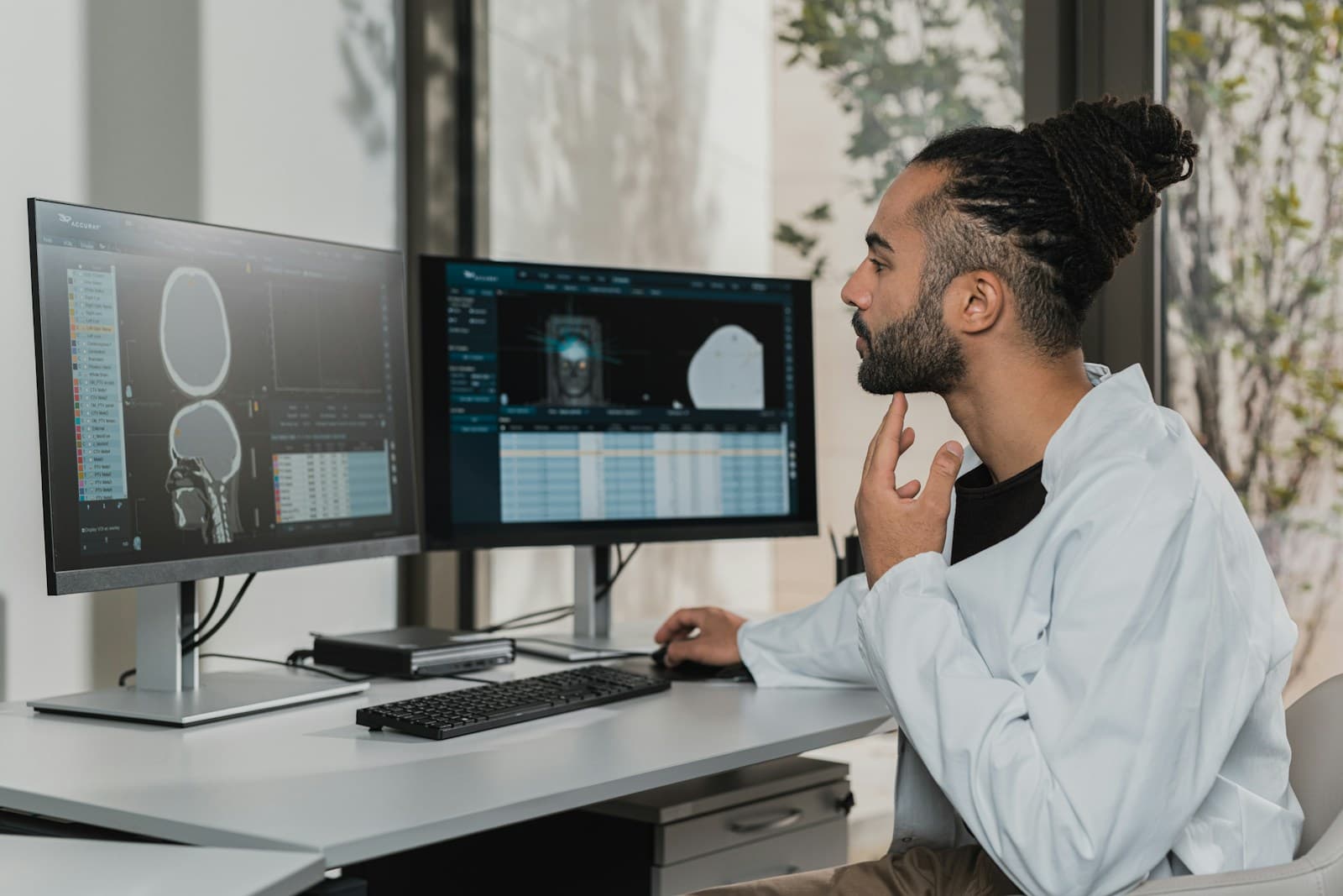An engineer working at a desk with a computer and monitors