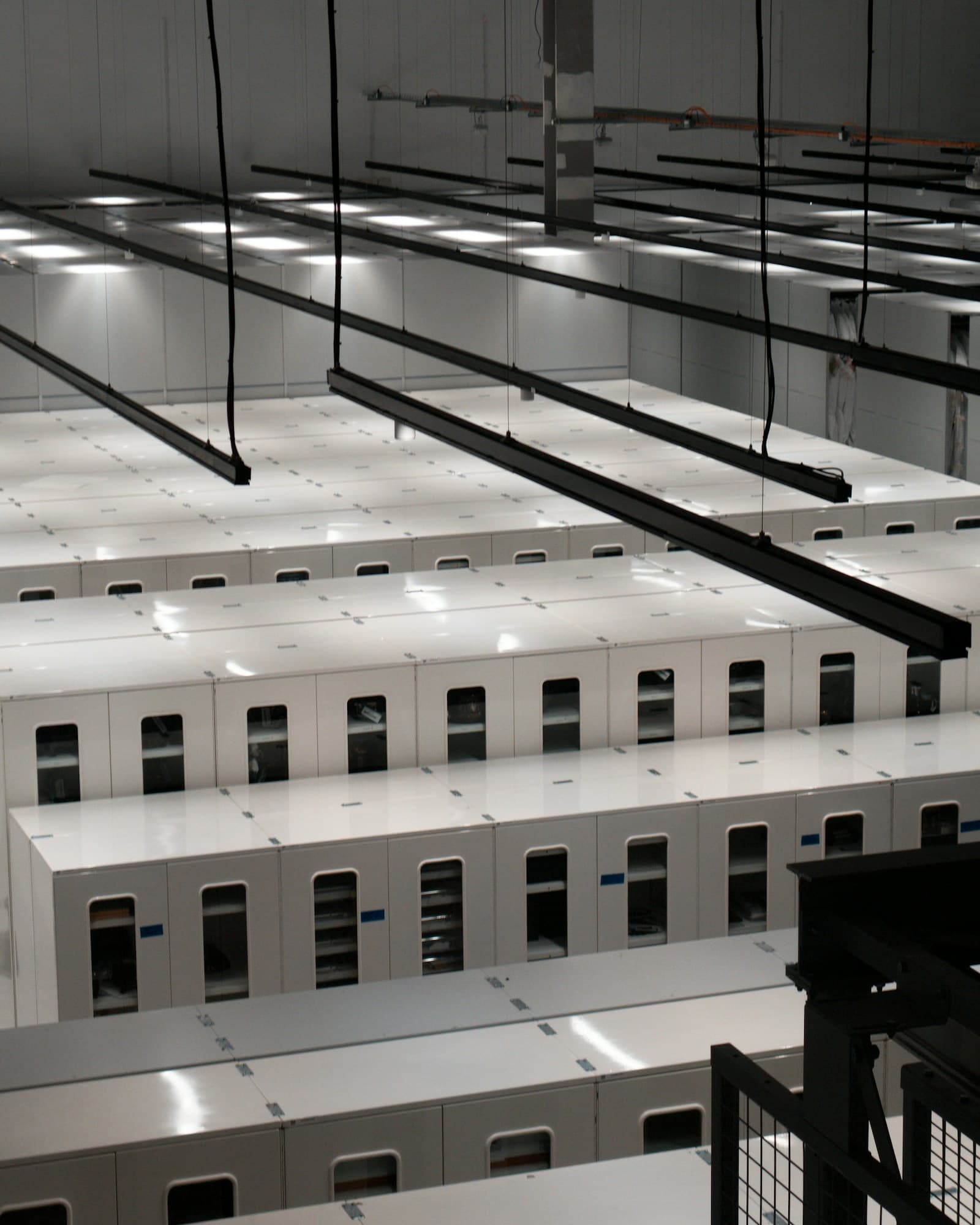 Rows of white server cabinets in a modern data centre
