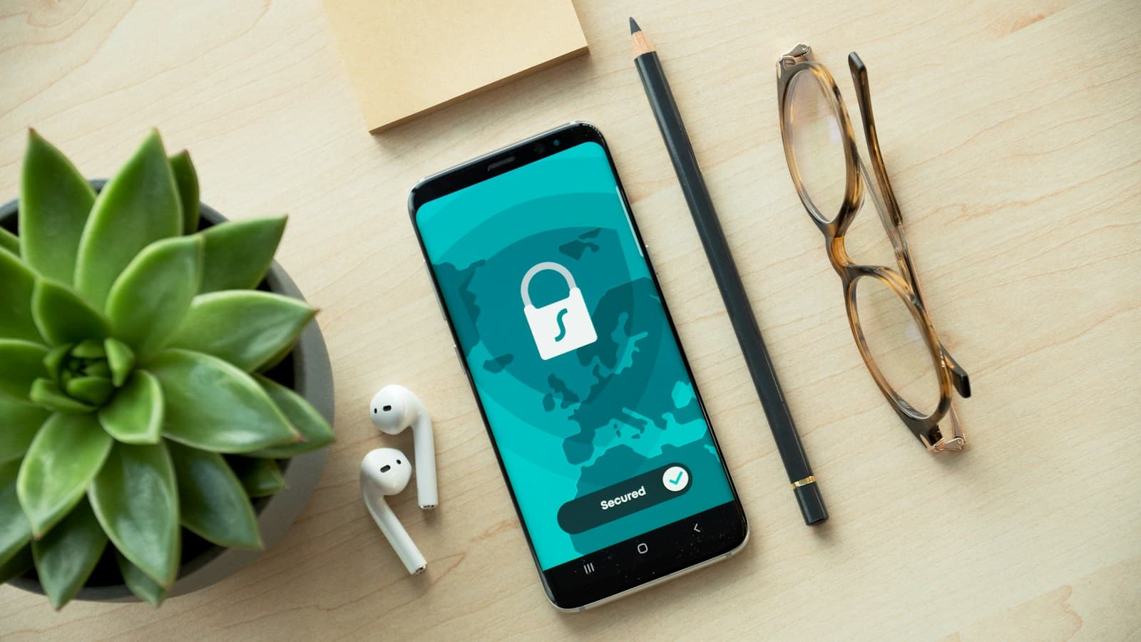 A smartphone showing a security lock screen on a wooden desk