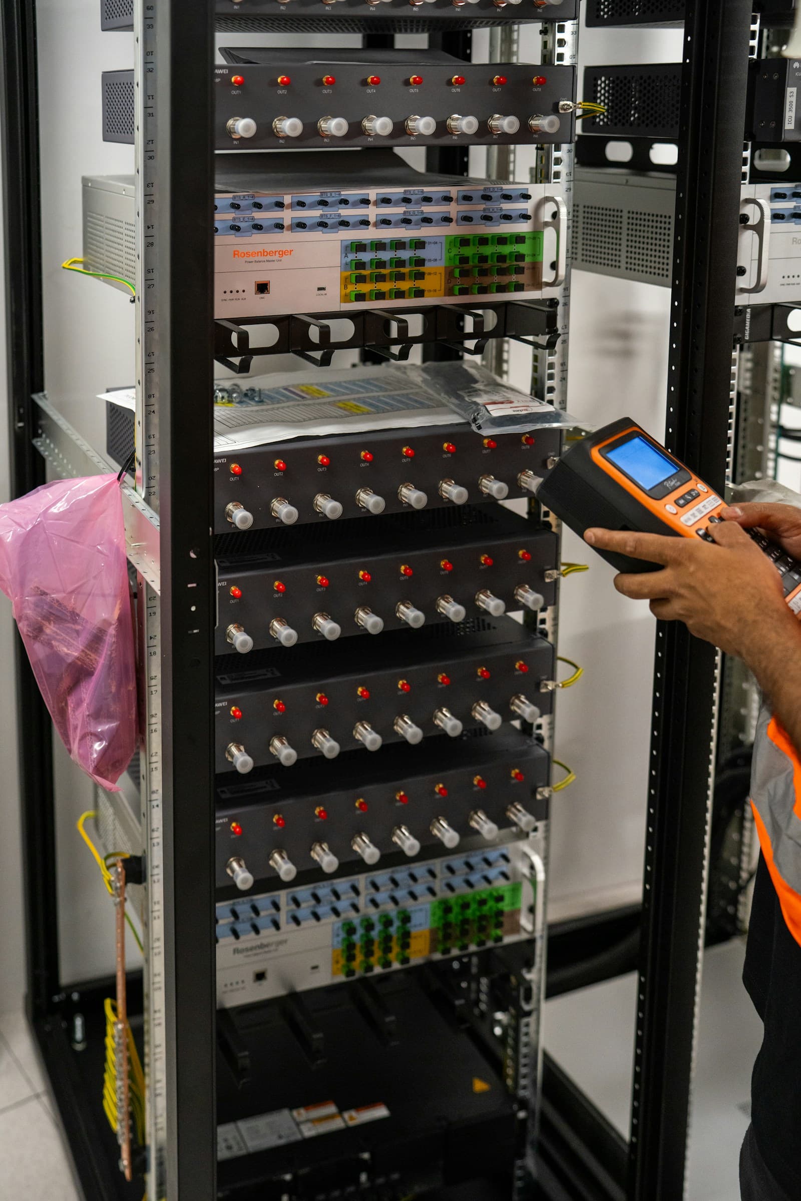 An engineer testing connections on a server rack