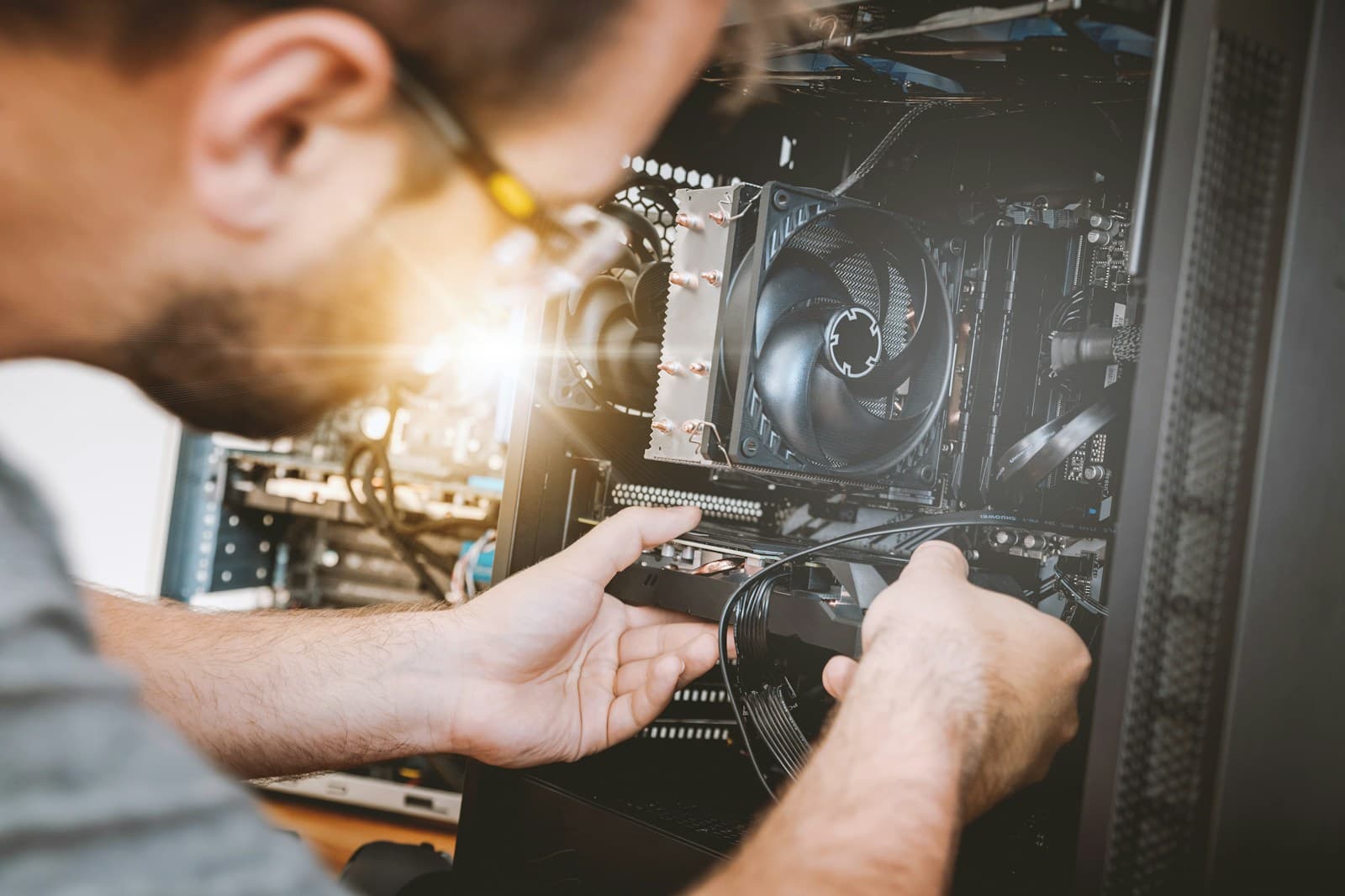 An engineer installing a component into a computer