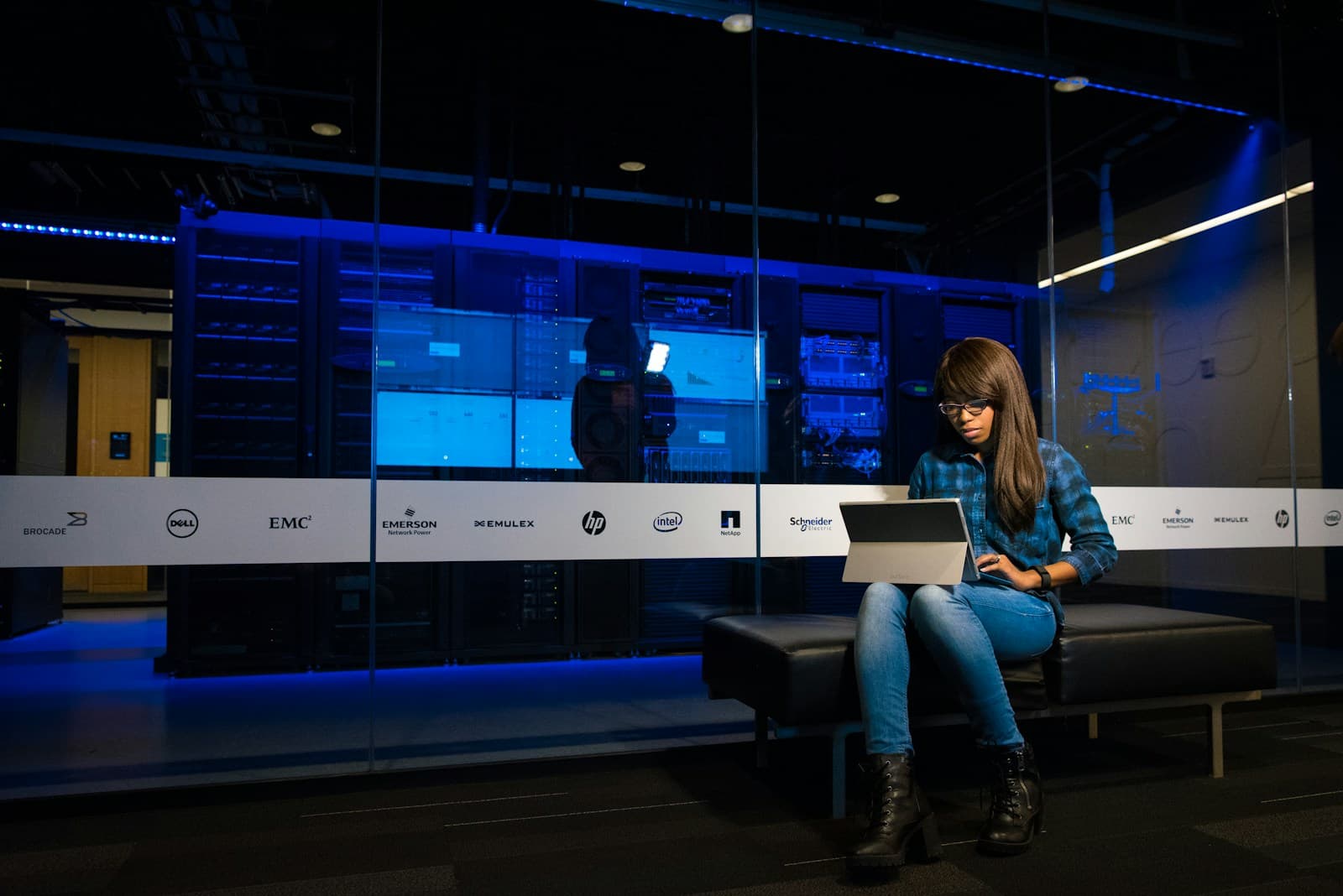 An engineer working on a laptop in a data centre