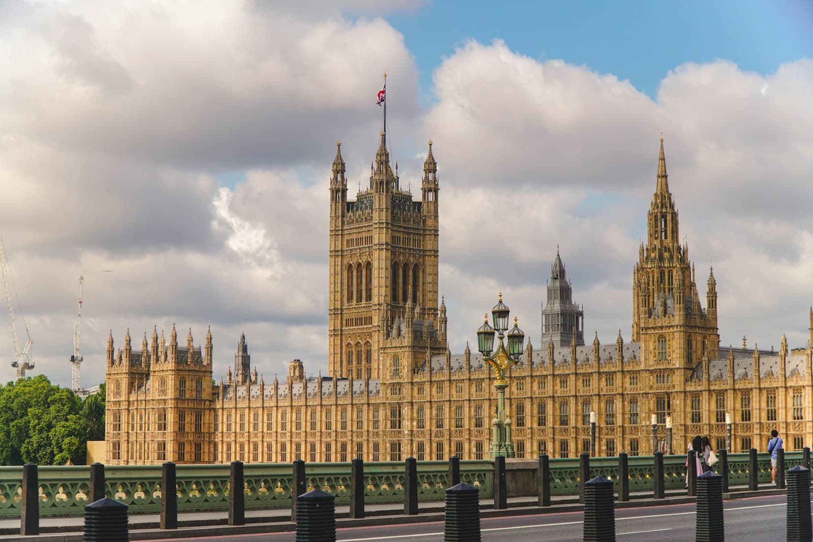 The Houses of Parliament in London under a partly cloudy sky