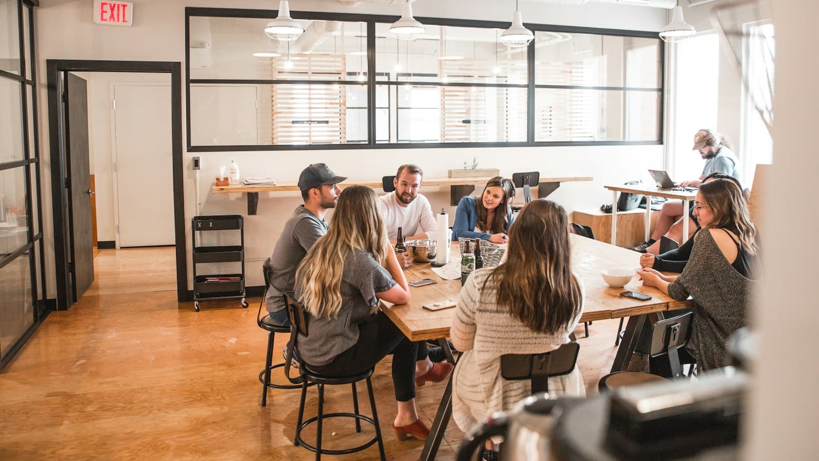 Colleagues talking around a table in a bright office