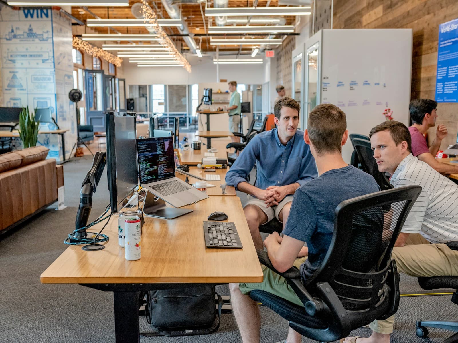 Colleagues working at desks in a busy open-plan office